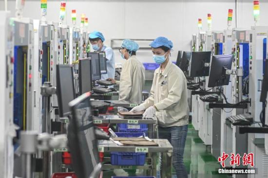 資料圖：2月20日，位于廣州南沙區(qū)的安捷利(番禺)電子實業(yè)有限公司內(nèi)，復工人員戴著口罩在生產(chǎn)車間有序工作。<a target='_blank' >中新社</a>記者 陳驥旻 攝